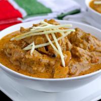 Balti Goat · Goat on the bone simmered with fresh onions and tomatoes in a creamy curry sauce.