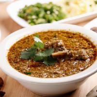 Goat Hara Masala · Goat on the bone cooked in curry sauce, simmered with tomatoes, freshly ground spices, herbs...
