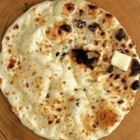 Naan · Tandoor-baked white flour bread served with a touch of butter.
