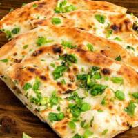Bullet Naan · Tandoor-baked white flour bread seasoned with jalapeños and cilantro, and served with a touc...