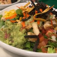 Baja Salad Bowl · Fajita chicken, black beans, corn, pico de gallo, and fresh avocado topped with tomatillo sa...