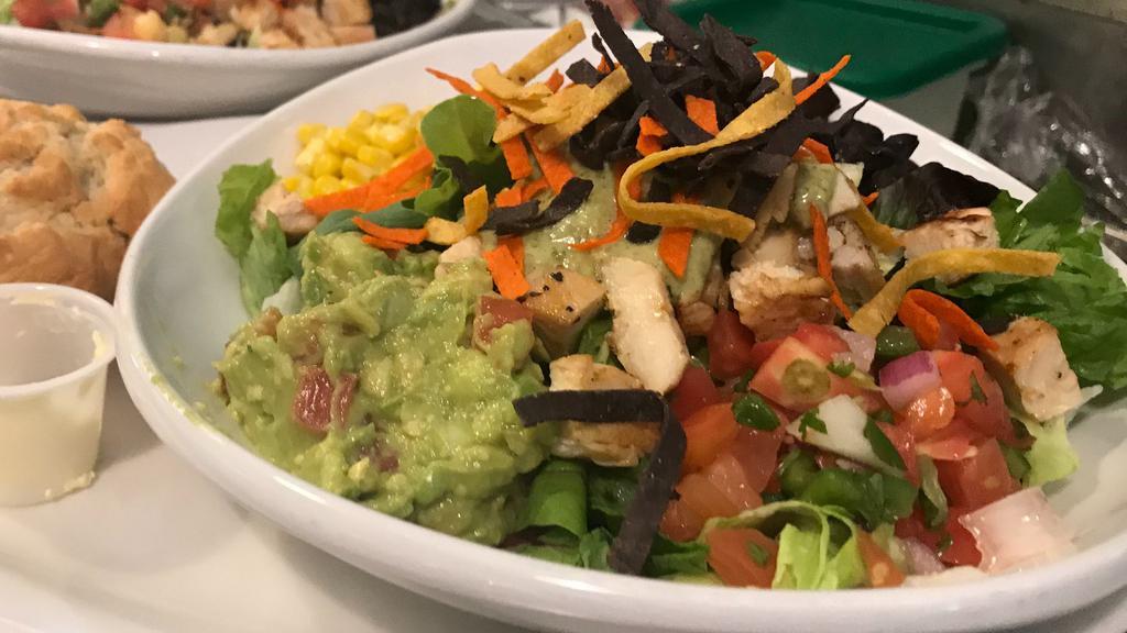 Baja Salad Bowl · Fajita chicken, black beans, corn, pico de gallo, and fresh avocado topped with tomatillo salsa and crispy tortilla strips. Served over Shredded Lettuce.