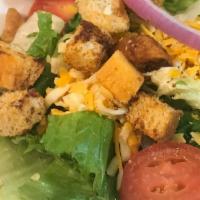 Dinner House Salad · Mixed house greens with tomatoes, red onions, Jack and Cheddar cheeses, croutons, and your c...