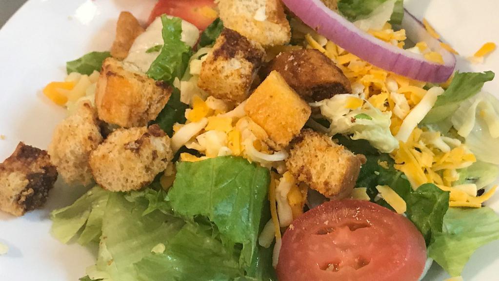 Dinner House Salad · Mixed house greens with tomatoes, red onions, Jack and Cheddar cheeses, croutons, and your choice of dressing.