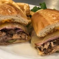 Cuban Sandwich · Pulled pork and shaved ham, served on grilled ciabatta bread with dill pickle slices, melted...