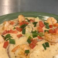 Shrimp & Grits · Jumbo Shrimp and Andouille Sausage in a bayou cream saucewith tomatoes, green onions and jal...