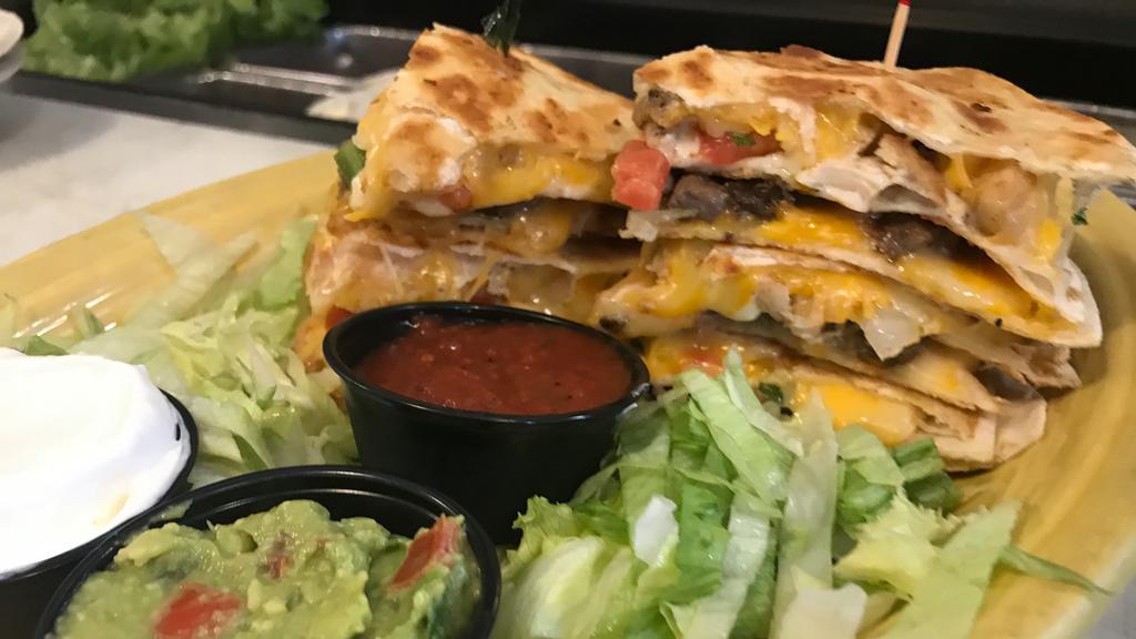 Double Stacked Quesadillas · Large flour tortillas filled with fajita chicken and steak, Pepper Jack cheese, Cheddar and Monterey Jack cheeses, and pico de gallo. Served with guacamole, sour cream, and wild red salsa.