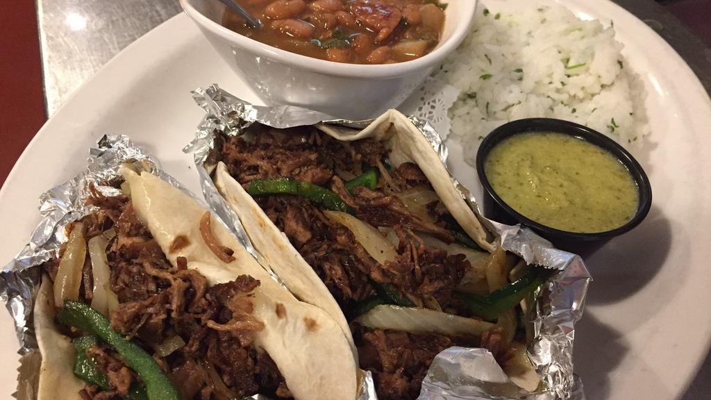 Dallas Brisket Tacos · Flour tortillas, melted Monterey Jack cheese, chopped brisket, grilled poblano peppers and white onions. Served with tomatillo salsa, borracho beans and mexican rice.