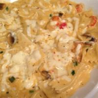 Cajun Seafood Pasta · Bowtie noodles tossed with shrimp, crawfish, mushrooms, garlic, green onions, alfredo sauce,...