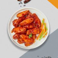 Baffling Buffalo Wings · Fresh chicken wings breaded, fried until golden brown, and tossed in buffalo sauce. Served w...