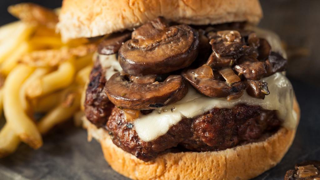 Mushroom Swiss Burger · 7 oz burger with mushrooms, swiss cheese, grilled onion & mayo on a toasted brioche bun.