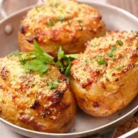 Baked Potato · Baked potato stuffed with brisket, smoked sausage or grilled chicken, butter, cheese and sou...