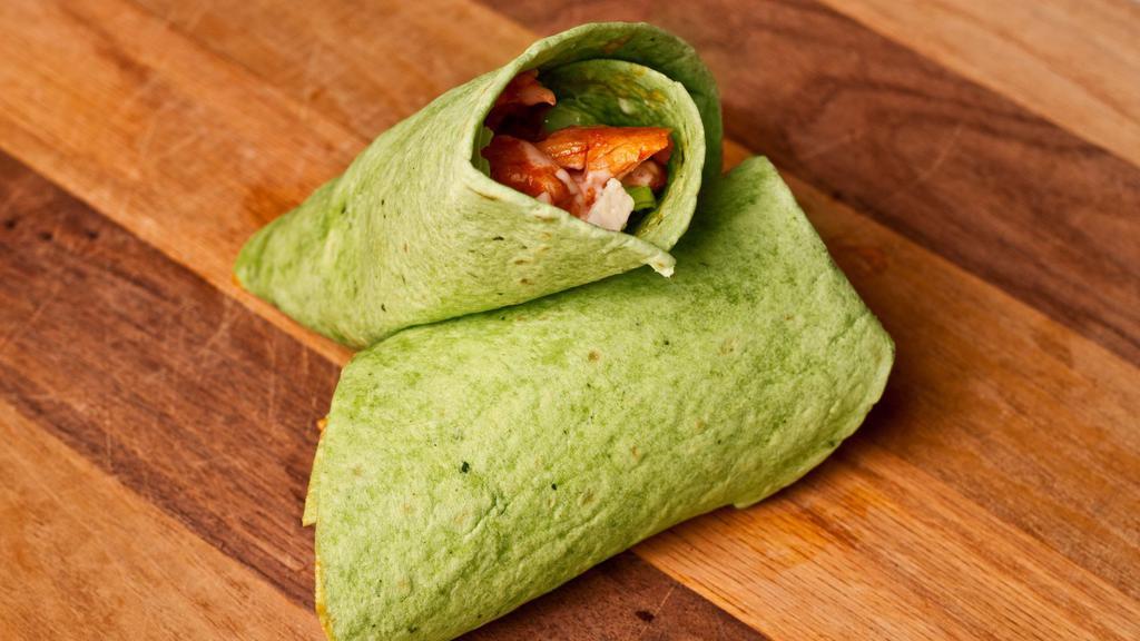Chicken Wrap · Grilled or fried chicken in a spinach tortilla with lettuce, bacon, tomatoes, cheese, choice of dressing or wing sauce served with house chips.