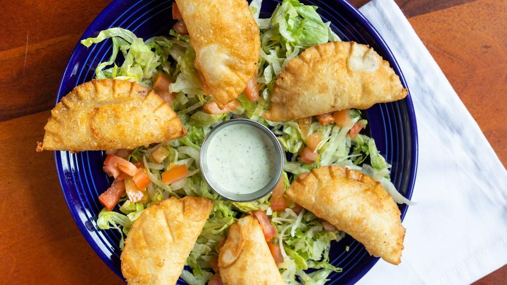 Empanadas · Six empanadas filled with picadillo and Monterrey Jack cheese, deep fried and served with our cilantro cream sauce.