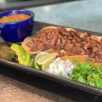 Street Tacos · Four minicorn tortillas filled with tender steak pieces  served with cilantro, fresh onions,...