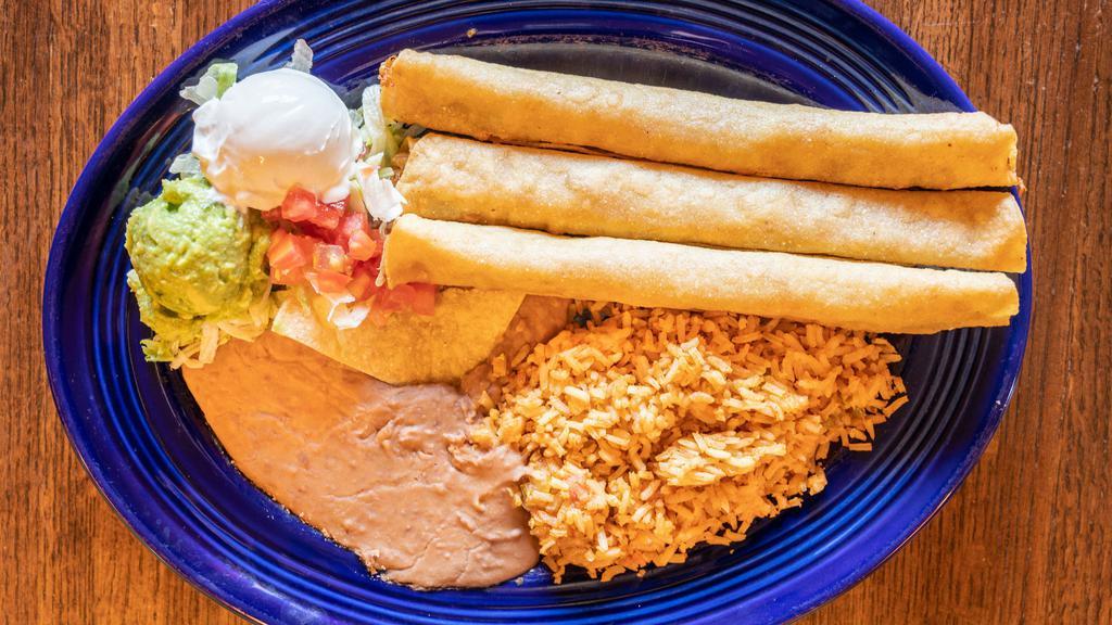 Flautas · Three chicken flautas with sour cream, guacamole, lettuce and tomato. Served with refried beans.