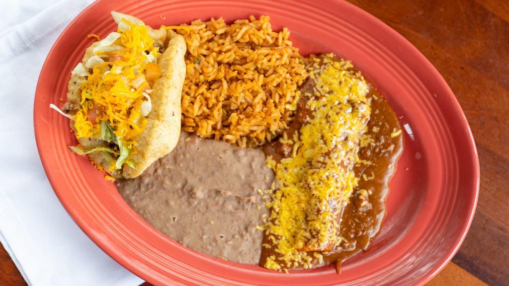 Saltillo Plate · Arthur's favorite! One beef puff taco and one cheese enchilada topped with our familia's special gravy and chili con carne.