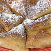 Sopapillas · Soft pillows of puffed pastry dusted with cinnamon and powdered sugar and drizzled with honey.