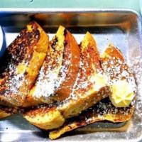 French My Toast · Two golden-brown french toasts with whipped honey butter and maple syrup and served with fru...