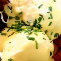 Eggs In Jail · Two poached eggs incarcerated in a circle of bacon and brioche toast with hollandaise and se...