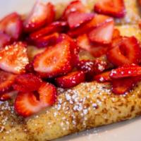 Strawberry Crepes · Delicate crepes filled with fresh strawberries and topped with more strawberries and whipped...