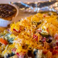 Migas · Scrambled eggs, tortilla strips, jalapenos, tomatoes and onion, topped with aged cheddar and...