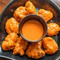 Boneless Chicken Wings · Tossed in your choice of BBQ sauce, buffalo sauce or dried lemon pepper seasoning. Served wi...
