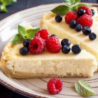 Fp'S Homemade Cheesecake · A slice of creamy cheesecake with fruit topping.