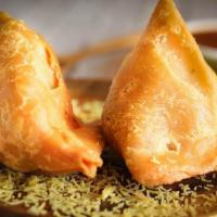 2 Pieces Samosa · Pastry triangles with savoury potatoes and peas. Vegan.