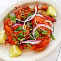 Chicken Tikka (Leg Quarter) · Skinless chicken leg quarter marinated in our aromatic herbs and spices, charcoal grilled.