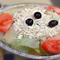Greek Salad · Served with mix of romaine, iceberg, red cabbage topped with tomatoes, onions, cucumbers, an...