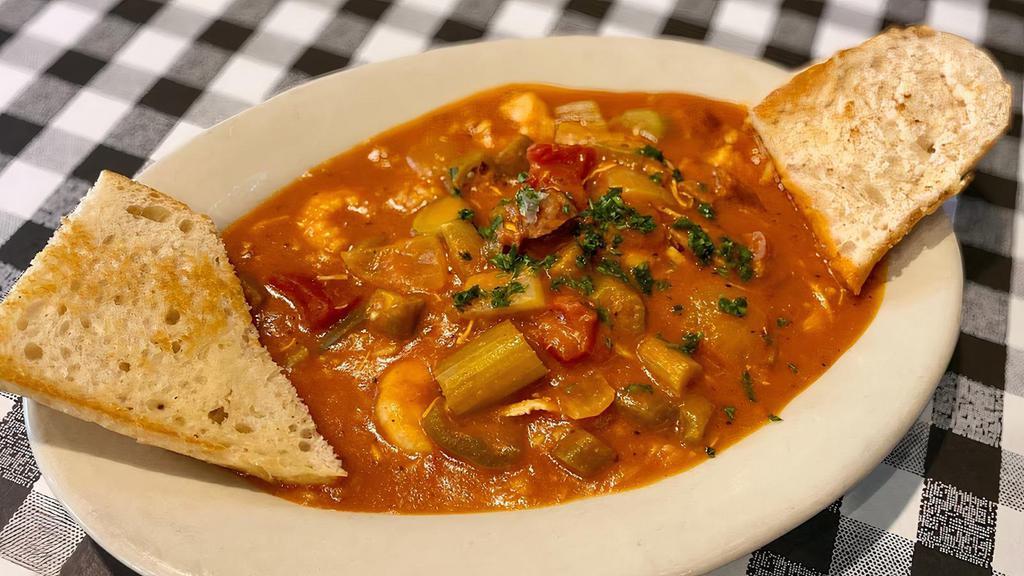 Shrimp Jambalaya · Jambalaya is a savory sauce consisting of tomatoes, onions and bell peppers with chicken, andouille sausage and okra poured over a bed of white rice topped with either our boiled shrimp, fried catfish or fried crawfish tails.