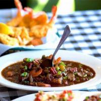 Grits And Gumbo · Traditional gumbo made with roux, okra, andouille sausage, and shrimp.