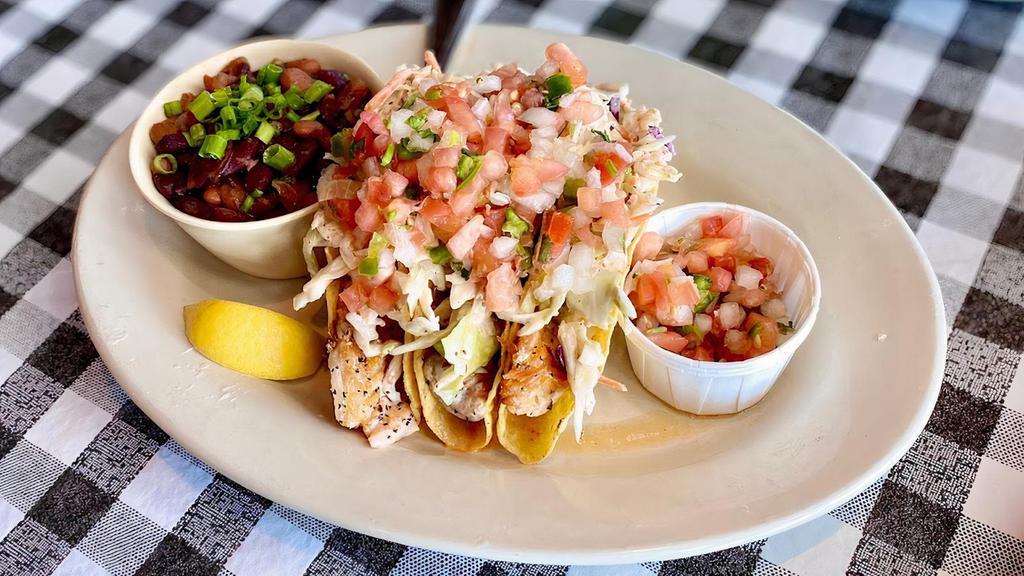 Grilled Tilapia Tacos · Three crispy corn tortillas stuffed with grilled tilapia,, pico de gallo, coleslaw, and comeback dressing served with rice and beans.