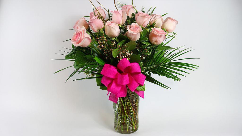 Lovely Pink - 12 Roses · Send love with one dozen premium pink roses or any color roses designed to give a great impression with beautiful foliage in a clear glass vase.