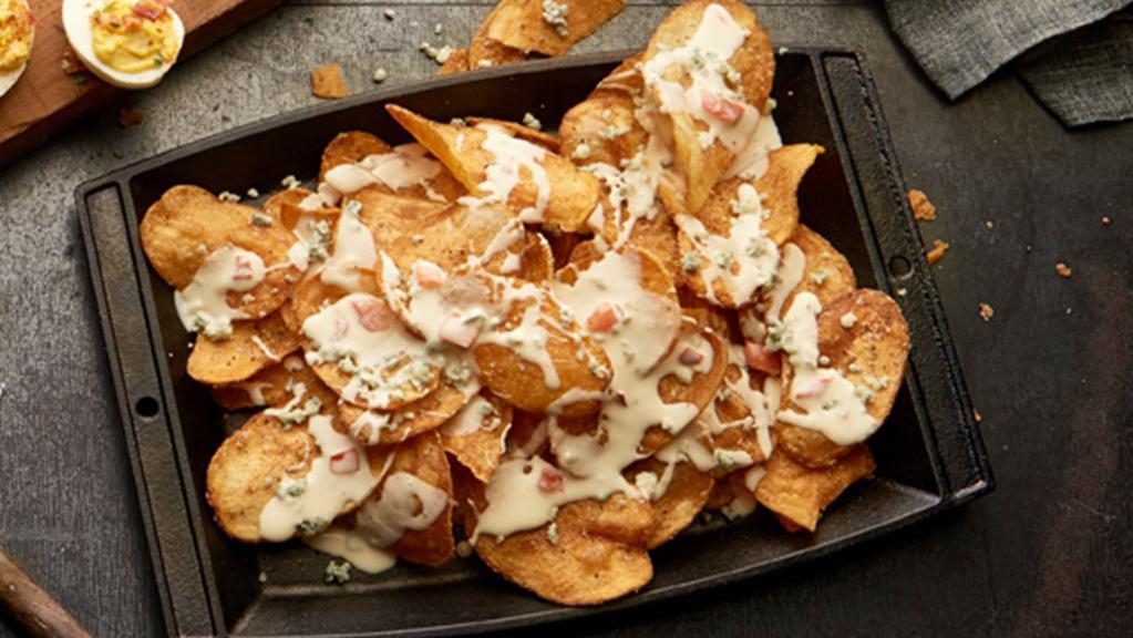 Bleu & White Chips · House-made potato chips with bleu cheese crumbles, green onion, and white cheese sauce.