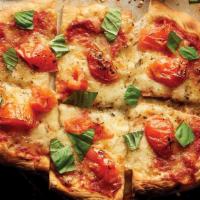 Margherita Flatbread · Fresh mozzarella, roasted tomatoes, shredded basil leaves, and hearty tomato sauce.