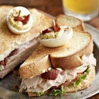 Turkey Club · Roasted turkey breast, bacon, lettuce, tomato, and mayo on country sourdough bread. Topped w...