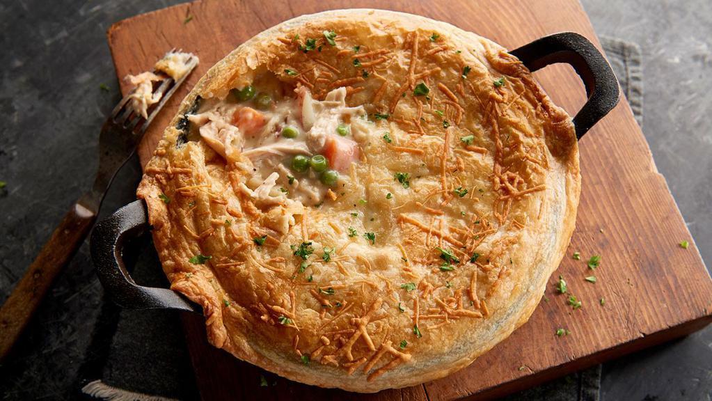 Chicken Pot Pie (Baked Fresh Daily) · Pulled chicken, red potatoes, peas, and thyme simmered slowly in a creamy herb sauce and topped with a flaky puff pastry.