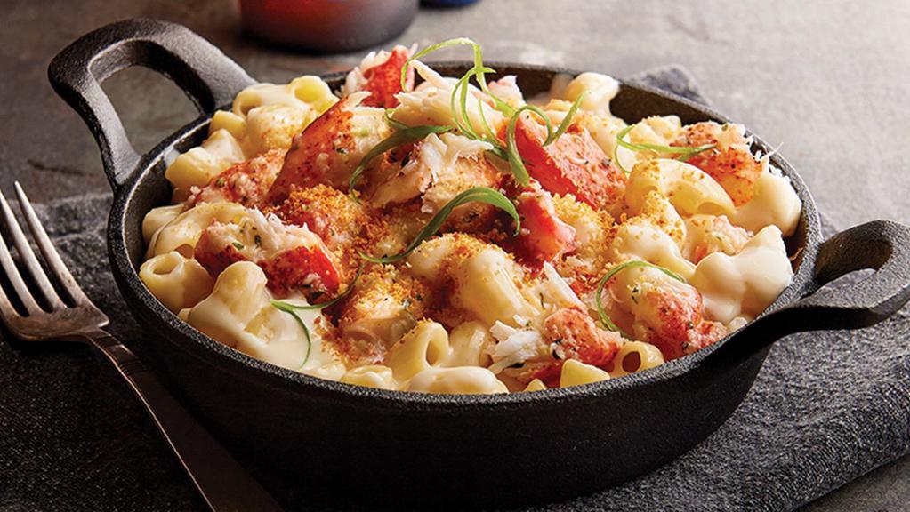 Lobster Mac & Cheese · Creamy white cheddar mac and cheese topped with lobster claw meat, panko bread crumbs, Parmesan cheese, and green onions.