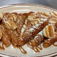 Cookie Butter French Toast · 6 Triangles of French Toast topped with bananas and drizzled with cookie butter