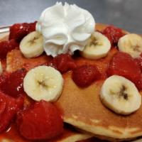 Strawberry Banana Pancakes · 2 fluffy pancakes topped strawberries and bananas
