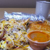 Machaca · Scrambled eggs with pot roast, tortilla chips, tomatoes, onions, jalapenos, cheese served wi...