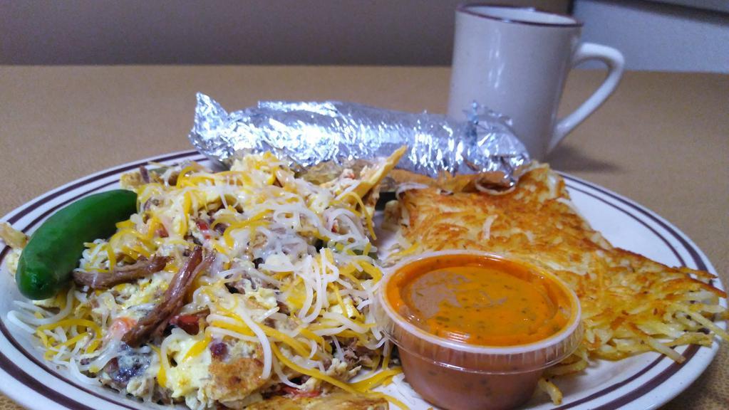 Machaca · Scrambled eggs with pot roast, tortilla chips, tomatoes, onions, jalapenos, cheese served with your choice of hashbrowns, red potatoes, or home fries and your choice of flour or corn tortillas. Served with a side of salsa.