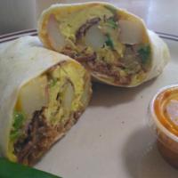 The Country Burrito · Scrambled eggs, shredded beef, red potatoes, onions, bell peppers, and cheese rolled into a ...