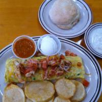 Chicken Fajita Omelette · Chicken fajita, onions, bell peppers, tomatoes, cheese and topped with sour cream.