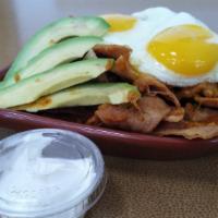 Chila Skillet · 2 Eggs any style served with tortilla chips, salsa, shredded cheese and avocados and sour cr...