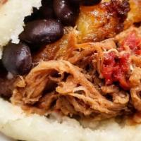 Pabellon Arepa · Shredded beef, fried maduro plantain, black beans, and white cheese.