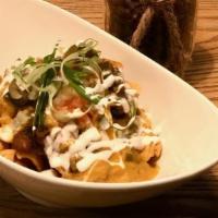 The Ultimate Frito Pie · A heaping pile of Frito's Super Scoops topped with house made chili, Queso, Sour Cream, Pico...