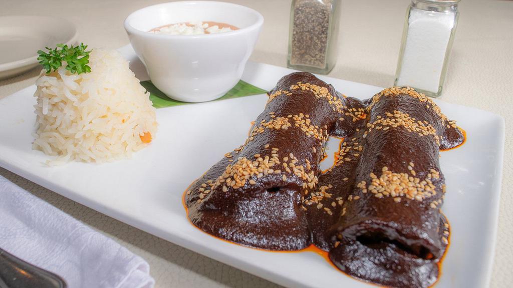 Lita'S Mole Enchilada · Two chicken enchiladas with mole sauce, served with Mexican slaw.